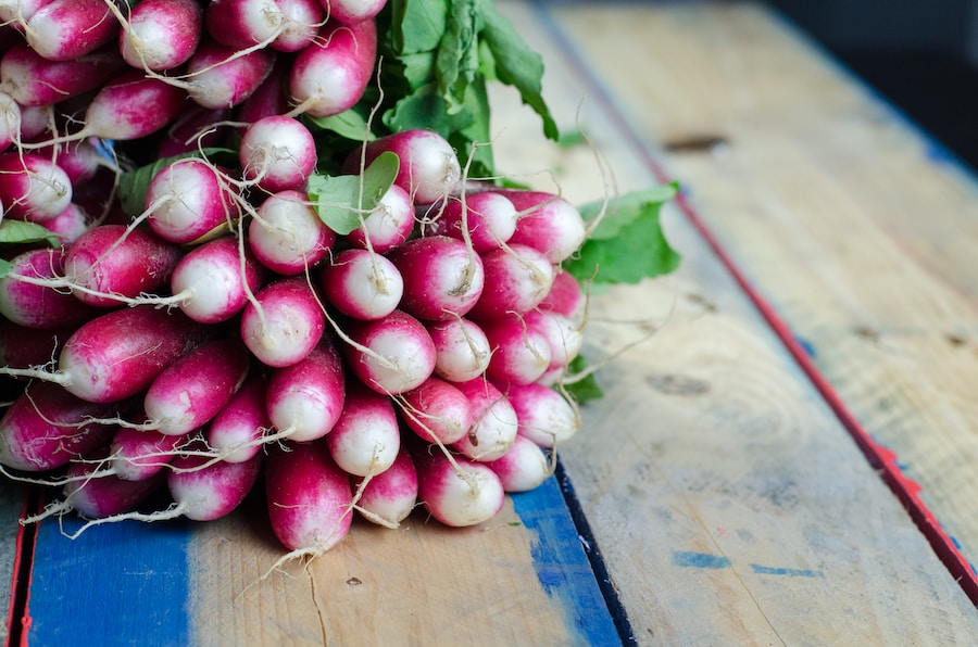 purple and white vegetables on brown surface