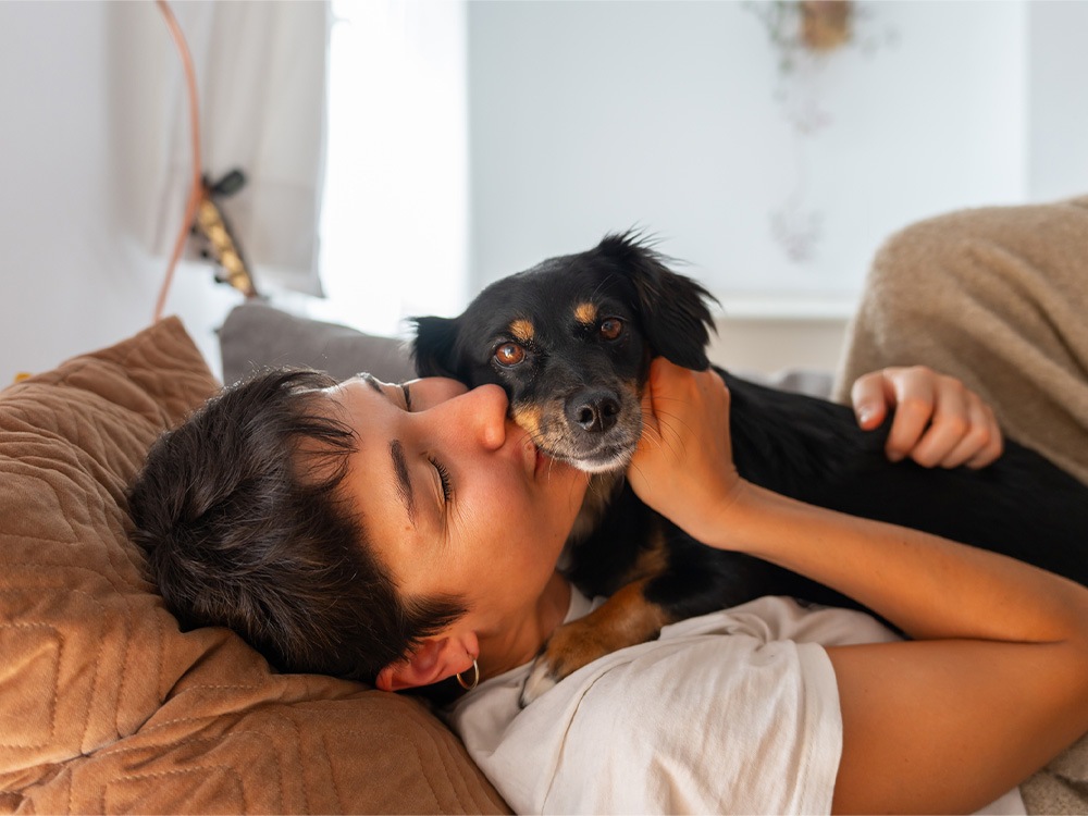 woman snuggling with a popular dog breed