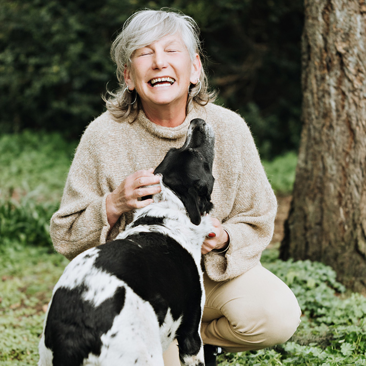 Older woman petting rescue dog