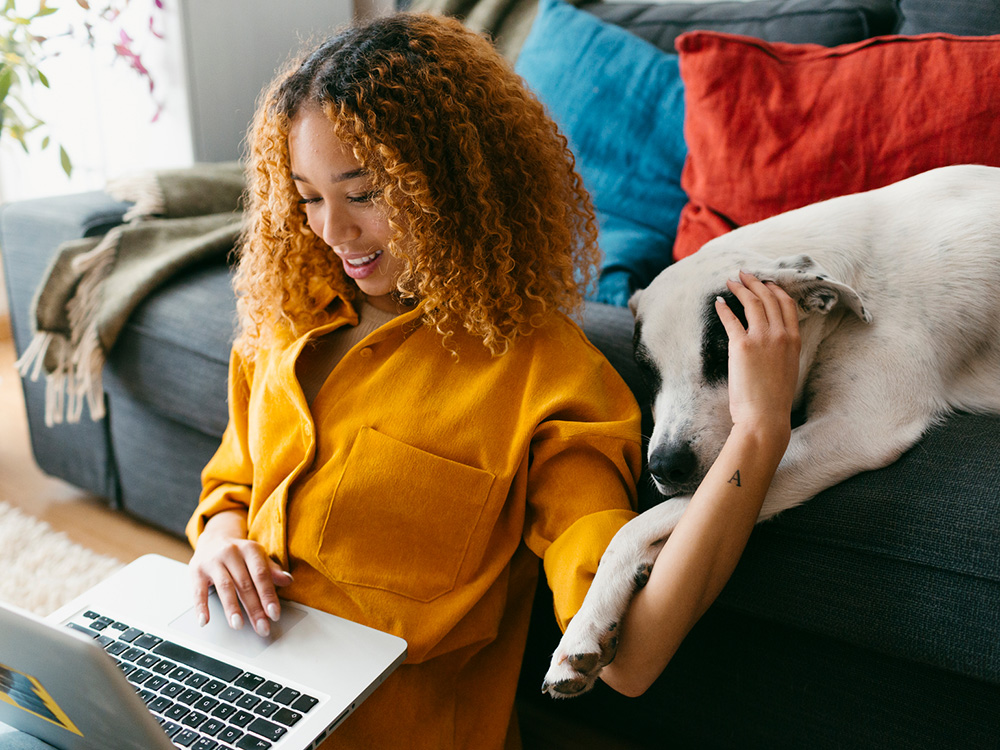 Woman looking at adoption paperwork with dog