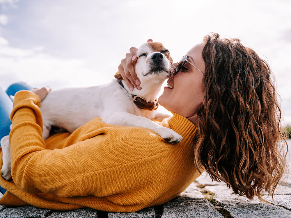 woman comforting shelter dog