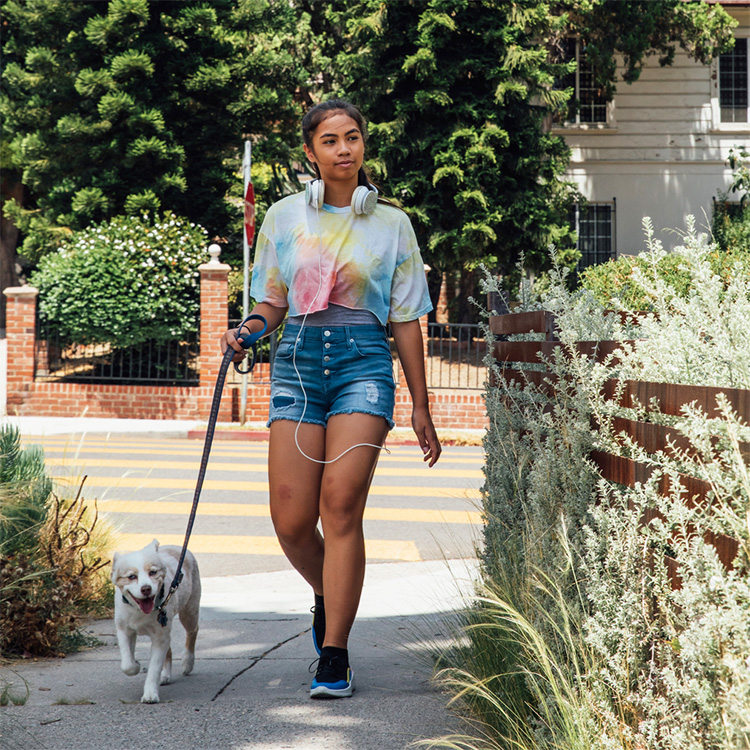 Woman walking new dog home on first day