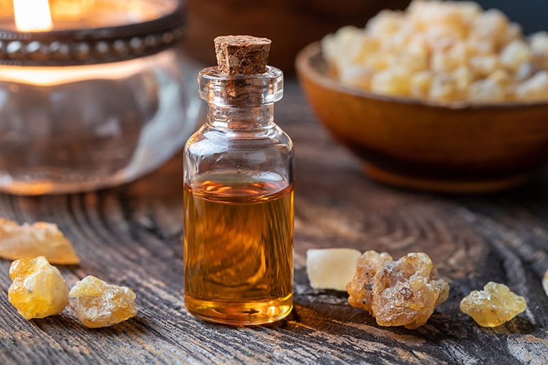 A bottle of essential oil with frankincense on a table