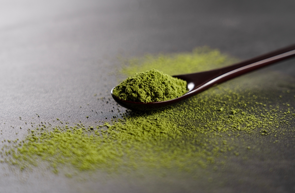 Matcha powder on wooden spoon